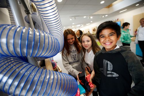 Smiling children playing at the Science Oxford Centre, developed for family public engagement with science.